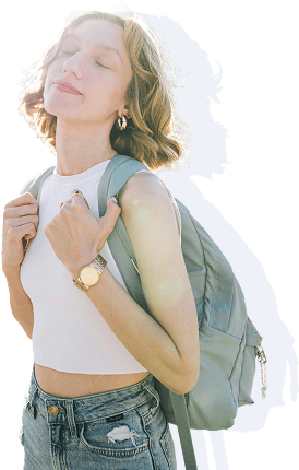 Young woman with a backpack smiling with eyes closed
